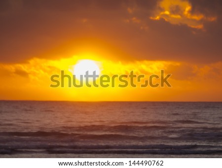 Golden Sunset Over the Ocean with People at the Beach