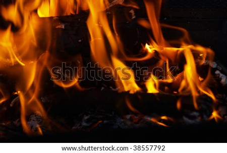 Flames in a fire pit with glowing embers