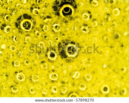 Soap bubbles with reflections macro with yellow colored background