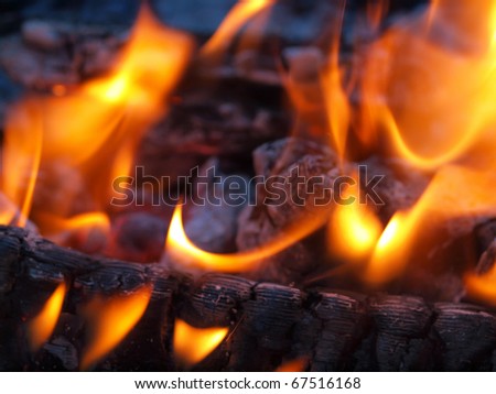 Background of Flames and Glowing Embers in a Campfire