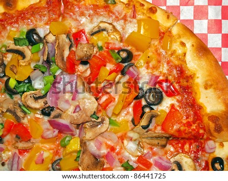 A Fresh and Healthy Vegetable Pizza on Red Checked Paper