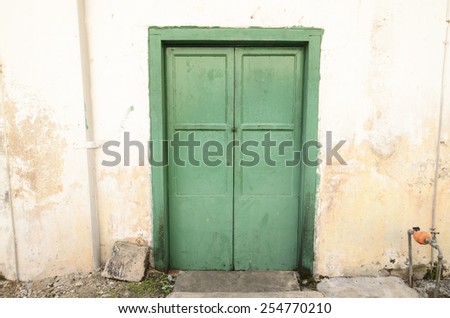 Painted steel backdoor of an old shop lot / Steel door / Provide security to property owners