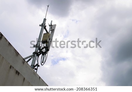 mobile phone transmitter antenna on sky with many clouds