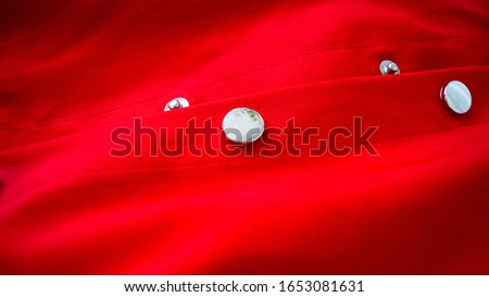 Metal clamping button on a red light product. The concept of style and sewing. ストックフォト © 