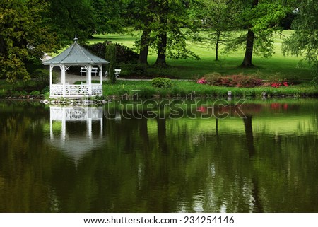 white gazebo on the water, white pavilion near lake in park