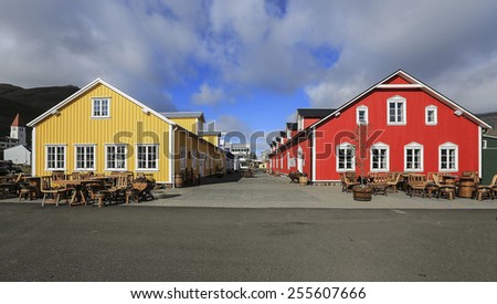 Beautiful red and yellow house against the blue sky in Akureyri Iceland.