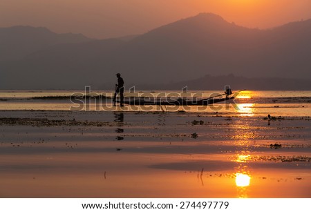 Fishermen in Inle lakes sunset, Myanmar. Fishermen is finish a day of fishing in Inle lake, Myanmar (Burma). Inle is one of the most favorite tourist places in Myanmar (Burma)