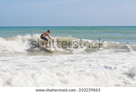 Scenic shot of a man surfing on ocean wave in Florida, 6 NOVEMBER 2014, Florida, USA