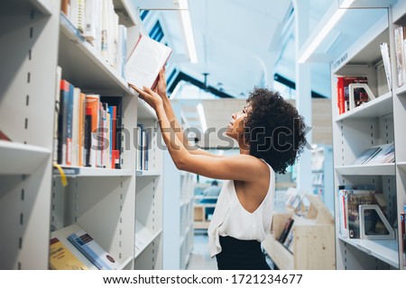 Similar – Image, Stock Photo Woman taking books out of cardboox. Unpacking parcel