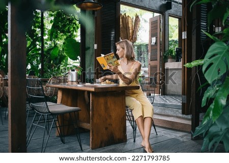 Similar – Image, Stock Photo Thoughtful woman reading book in living room