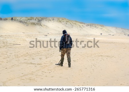 Treasure hunter with his metal detector at the Biscarosse Beach, France