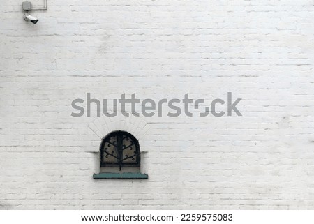 Similar – Foto Bild Ein kleines Fenster mit Gardiene in einer mit wildem Wein bewachsenen Mauer im Winter