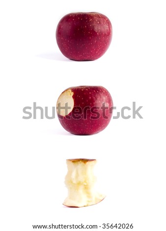 three red apples and apple cores over white