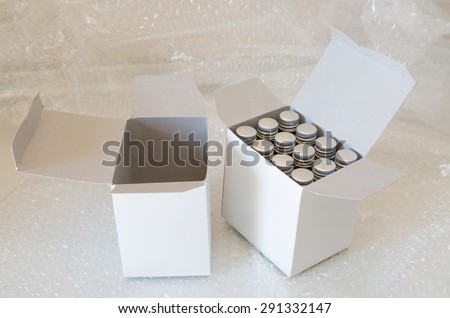 Medicine bottles in white paper box and air bubble