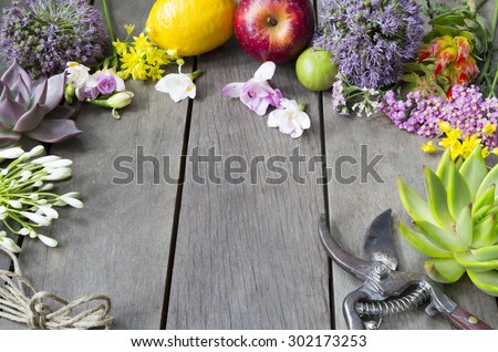 still life of arranging flowers and fruit on wooden background