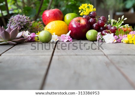 composition of fruit and flowers on wood table