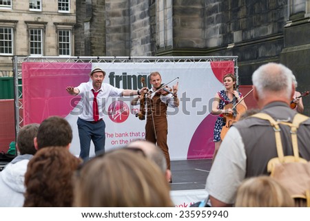EDINBURGH, SCOTLAND: AUGUST 20, 2014: Group of artists during their Fringe performance at Royal Mile, Edinburgh