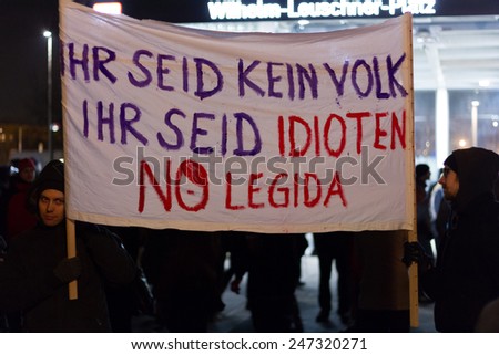 Leipzig, Germany - January 21: German protestants holding sign stating \'YOU ARE NOT PEOPLE, YOU ARE IDIOTS, NO LEGIDA\' on January 21, 2014 in Leipzig, Germany