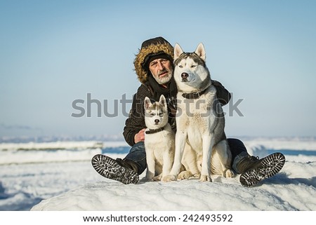The Old Man and sled dogs on an ice floe.