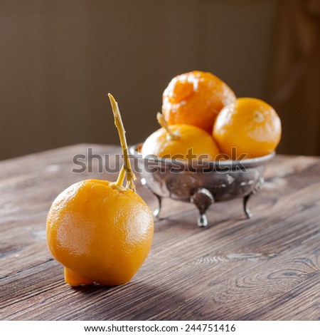 Moroccan pickled lemons in a metal bowl on a wooden background