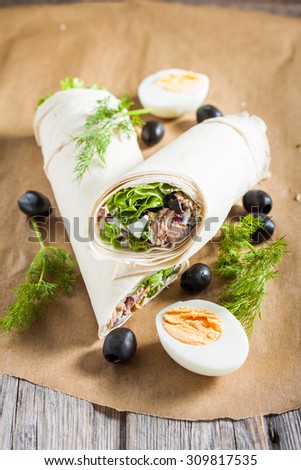 salad with tuna, olives and egg  in pita bread