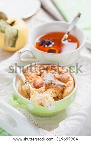 Clafoutis apple on a tray. Breakfast with pudding and tea on a white tray