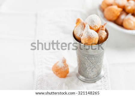 donuts with powdered sugar on a white background. French traditional dish \