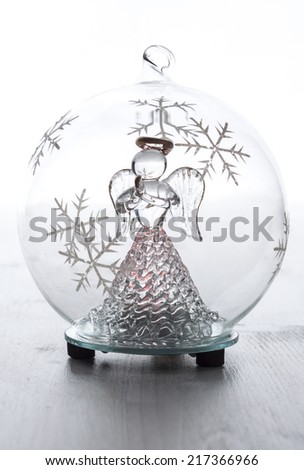 Christmas glass ball with angel inside on white background.