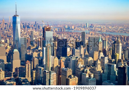 The city skyline of New York City in USA, United States on a cloudy, blue sky day with iconic buildings  from aerial, point of view. 