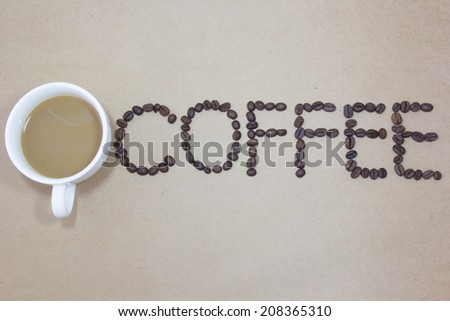 coffee / Claude\'s coffee bring up a letter./ Brown background recycled from scrap wood.