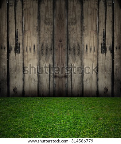 weathered barn wood background with knots. old wood. green grass floor
