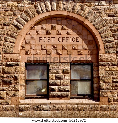 Post Office written atop on old style window.