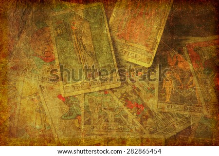 A textured, grunge background image of a group of scattered tarot cards from the major arcana.