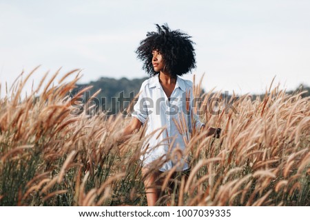 Similar – Image, Stock Photo Fashionable young ethnic lady standing near yellow wall and closed eyes