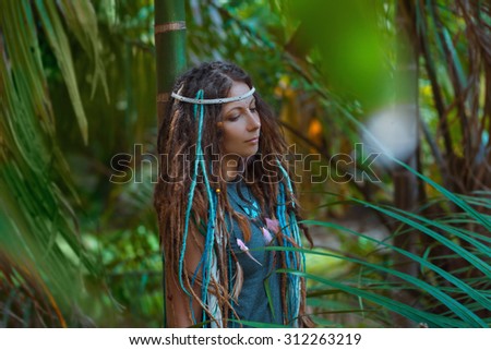 sensual portrait of young caucasian woman in jungle forest