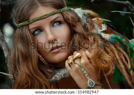 portrait of wild woman with feathers in her hair