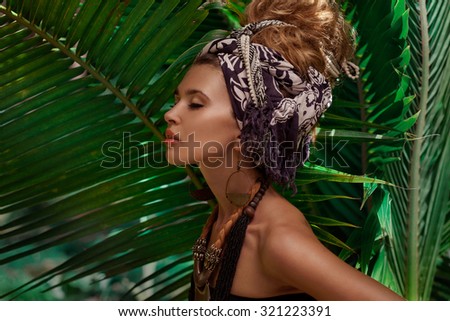 young caucasian woman in turban with jungle background
