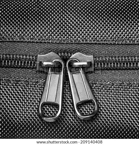 Metal zipper close on black synthetic fabric
