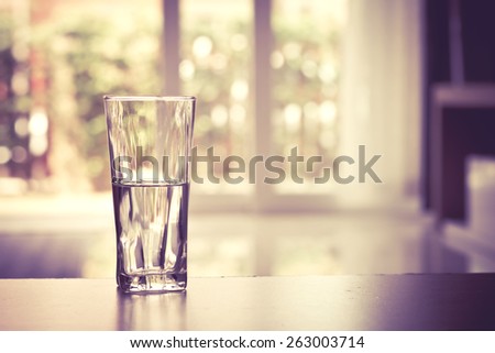 closeup Glass of water on table in the living room , vintage and retro style