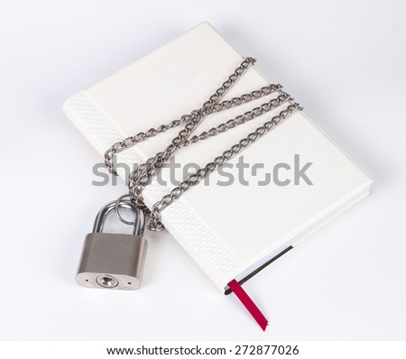 A padlock protects the book in a concept on protect the secret information