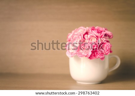 selective focus with extremely shallow DOF of Fresh pink carnation flower on wooden shelf background