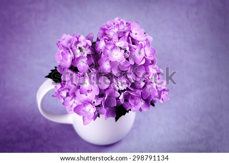 selective focus of the sweet purple hydrangea flowers in white vase in still life vintage style