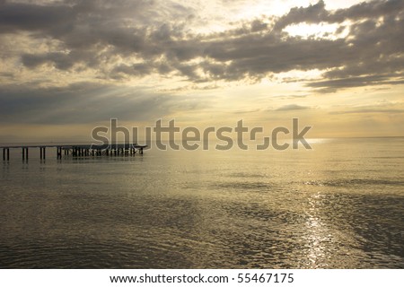 The morning sea and pier leaving in a distance