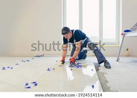 Similar – Foto Bild Handwerker beim Verlegen von Fliesen auf einer Terrasse