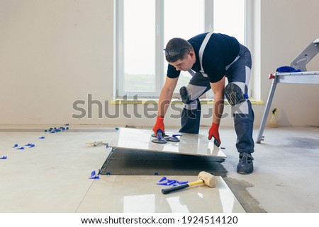 Similar – Foto Bild Handwerker beim Verlegen von Fliesen auf einer Terrasse