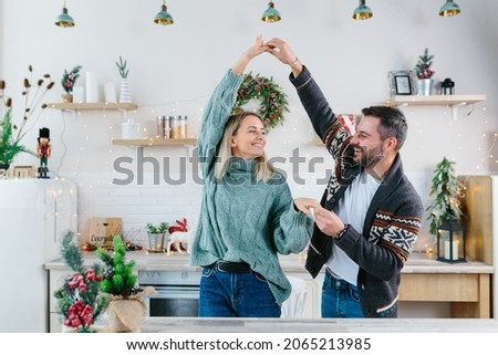 Image, Stock Photo Young woman in christmassy clothes looks smiling at a christmas present