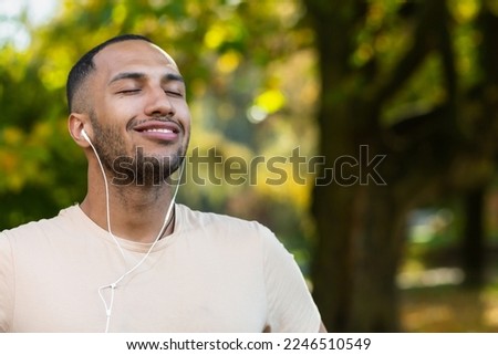 Similar – Image, Stock Photo Ethnic sportsman in headphones standing against gray wall