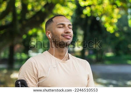 Similar – Image, Stock Photo Ethnic sportsman in headphones getting ready for running