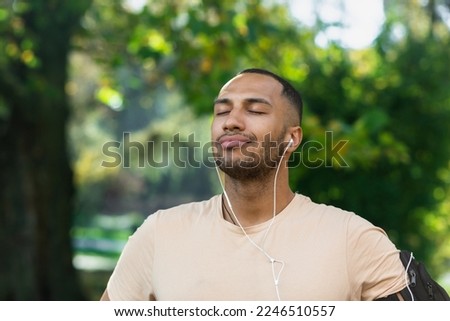 Similar – Image, Stock Photo Ethnic sportsman in headphones getting ready for running