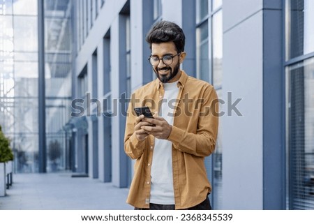 Similar – Image, Stock Photo Young man using mobile phone while walking outdoors